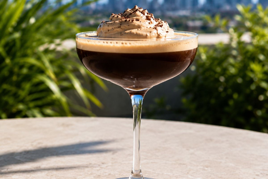 Espresso Martini topped with Espresso Martini whipped cream on a table overlooking the city.